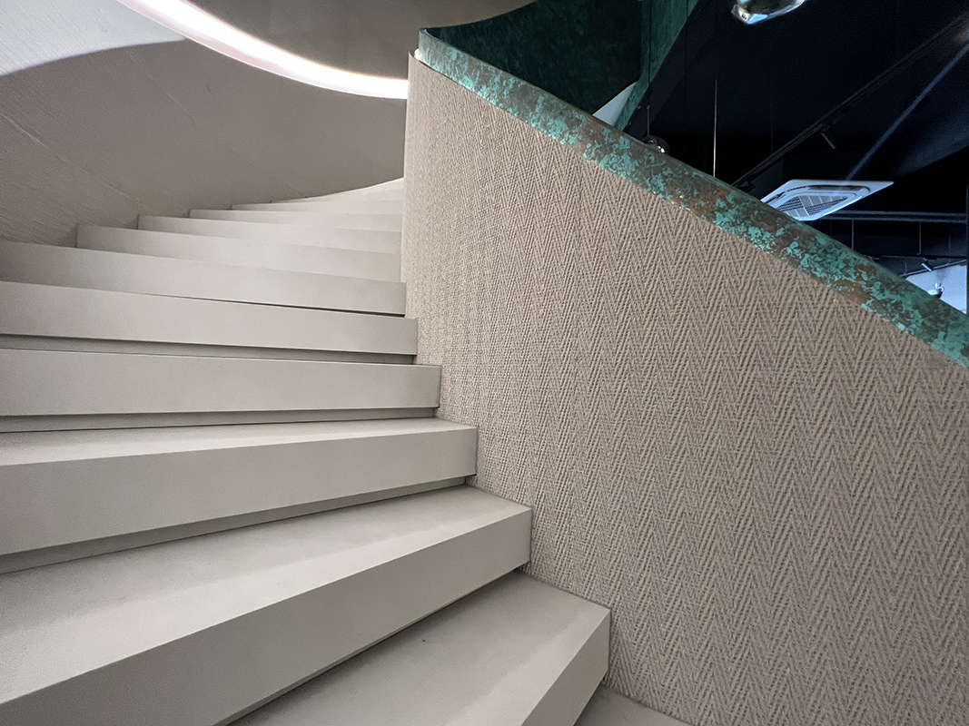 Client-supplied architectural surface detail in a commercial interior